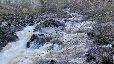 River Dee fast flowing due to high water level during the winter at the Bridge Stock Footage 228273899