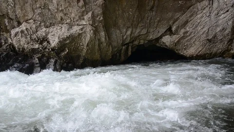 River disappears into a cave. Subterranean river. River enters the underground Video stock 106467236