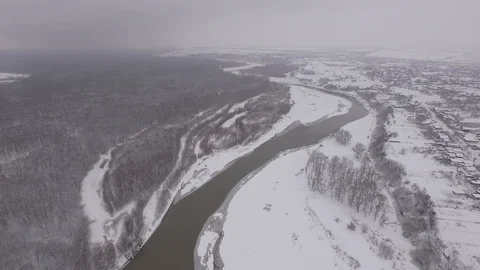 The river divides a small town and forest, the winter season Stock Footage 85568667