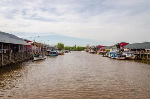 River dock with boats on a day with clouds Stock Photos