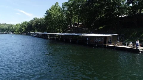 River drone shot with dock and fisherman casting Video stock 93382300
