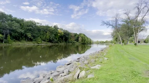 River Edge with Trees Day 4K HDR Stock Footage 250368863