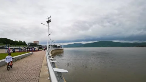 River embankment, lantern with wind generator and solar battery 스톡 동영상 204764336