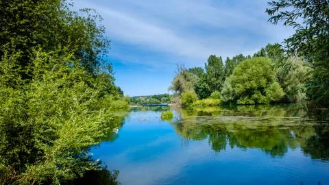 The River Eure, a tributary of the Seine, at the confluence of the two rivers Stock Photos