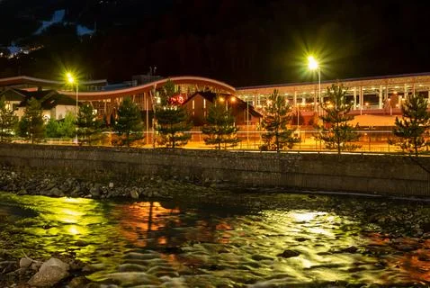 River with evening lights reflection in ski resort Stock Photos