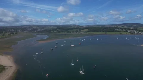 River Exe, South Devon, England: DRONE VIEWS: Moored Yachts &amp; Boats on the Exe Stock Footage 247825343