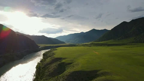 River in a field against the background of a mountain Stock Footage 245135786