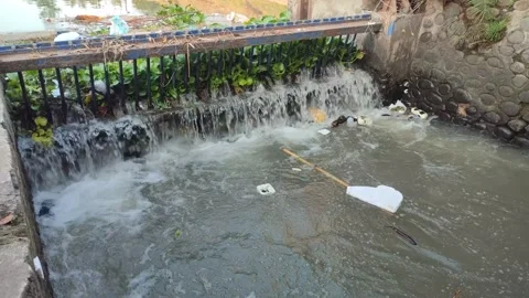 River fitted with iron nets to filter out trash. Video stock 247156331