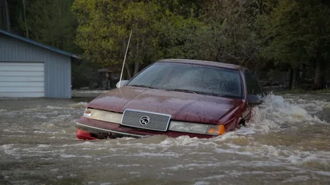 River flooding - flood - car under water -  mission creek Kelowna BC Stock Footage 88973457