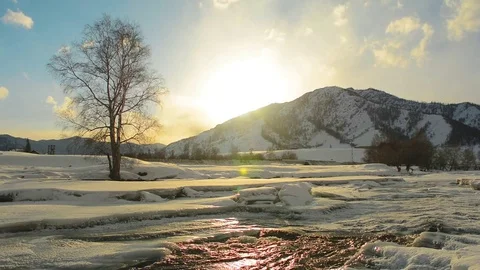 River flow. Glitter in the sunset. The cold winter in the mountains. Stock Footage 82450964