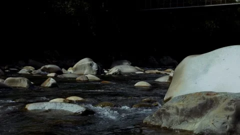 River Flow Over White Rocks with Tree Shadows Stock Footage 321320956