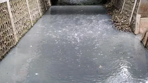 The river flow is polluted with various kinds of dirty materials Video stock 302326711