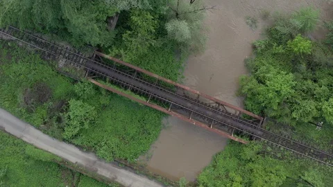 River flow under the bridge with railway track 4K aerial video Stock Footage 113886565