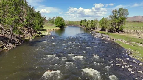 River Flowing Across a Wide Open Plain Stock Footage 335263486