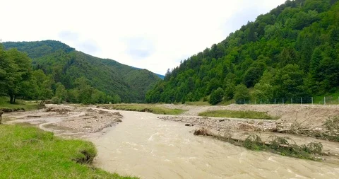 River flowing and mountains covered with green trees Stock Footage 103305910
