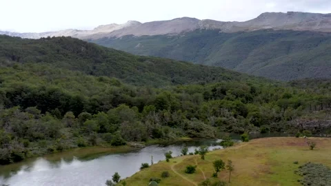 River flowing from the Andes mountain range through the Tierra del Fuego Stock Footage 255978175
