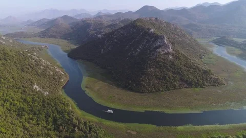 River flowing around the mountain. View from above Stock Footage 80710439