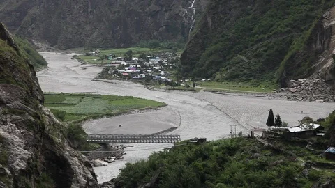 River Flowing Away from Himalayan Town Stock Footage 86758307