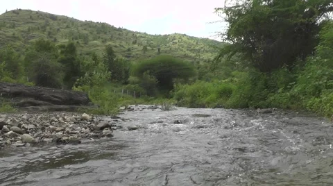 River Flowing Between Big Green Mountains Nature Scenery Background Footage Stock Footage