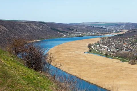 River flowing between hills and villages in rural areas Stock-Fotos
