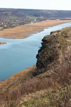 River flowing between hills and village in rural areas Stock Photos