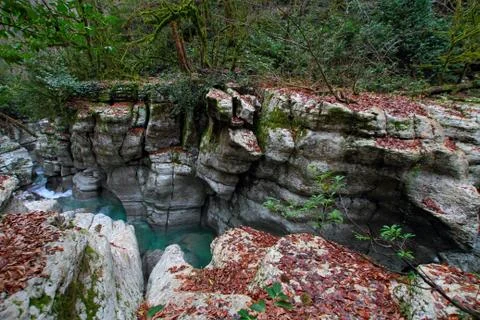 River flowing between the quaint rugged coves of the coast. Stock Photos