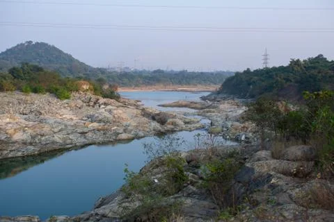 A river flowing down the mountain with rocks on both sides Stock Photos