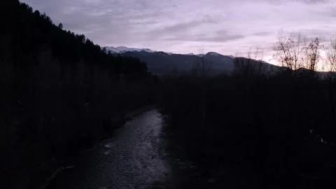 River flowing at dusk in front of snowy mountains Stock-Footage 141452608