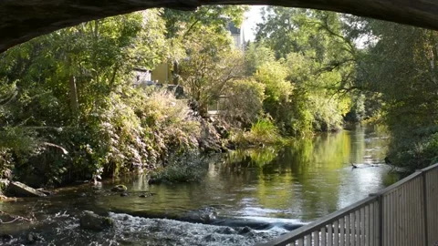 A River Flowing Gently Under A Stone-built Bridge Stock Footage 163053648