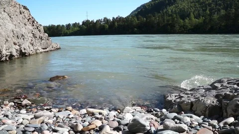 River flowing in grassy banks with trees Stock-Footage 76951373