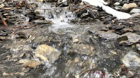 River flowing on mountain with snow wintertime holidays trip Stock Footage 127298238