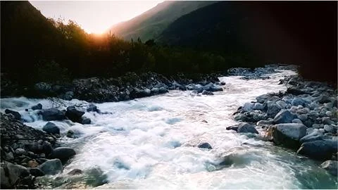River Flowing in Mountainous Landscape Stock Photos