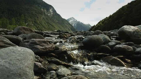 River Flowing in Mountains Stock Footage 82677132