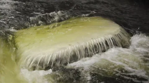 River flowing over ice chunk Stock Footage 40645746