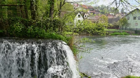 River flowing over manmade cascades in small town in Slovenia Stock Footage 190013592