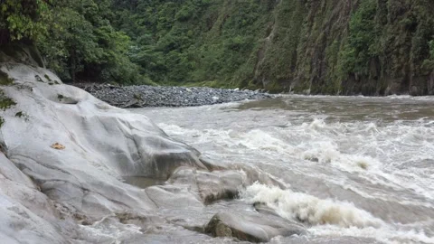 A river that is flowing over the rocks next to it with clear sign of wear Stock Footage 143676447