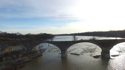 River flowing past abandoned bridge that is falling apart Stock Footage 73136686
