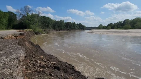 River Flowing Past the Road Stock Footage 274242831