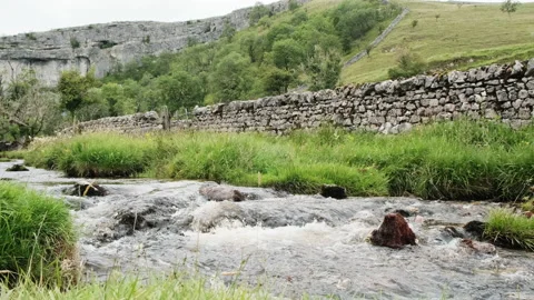 A river flowing rapidly in slow motion in England Stock Footage 136423725