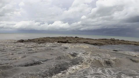 River flowing into the sea, ocean during the rainy season with rocks Stock Footage 159084875