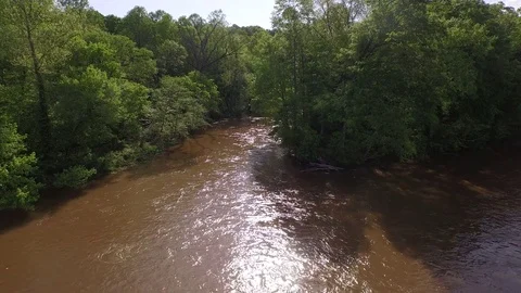River flowing slow push to trees 4K Drone shot Light sparkling on the water Stock Footage 85187411
