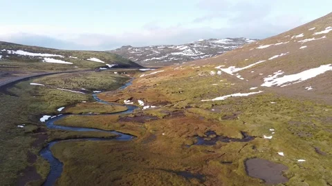 A river flowing through a cold valley in Iceland Stock Footage 168481332