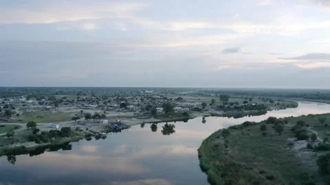 RIver flowing through dry town in African Wilderness Stock Footage 347658372