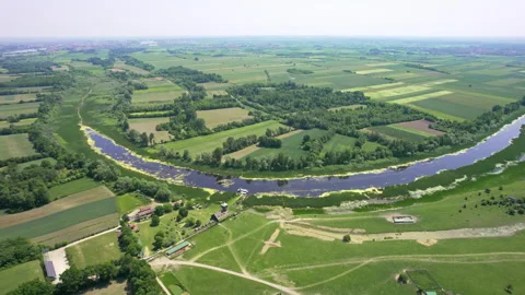 A river flowing through green plain countryside in nature reserve Zasavica Stock Footage 263153333