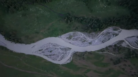 River flowing through green valley at dusk Stock Footage 312448550