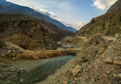 River flowing through hydroelectric construction site in mountainous region Stock Photos