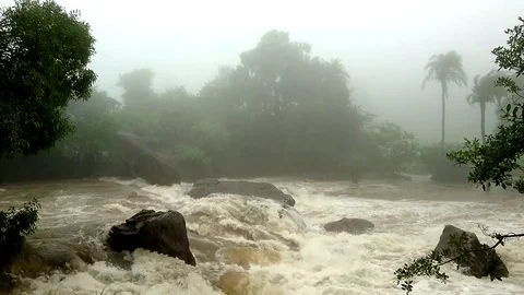 River flowing through Lush Green Foggy Mountains of Udaipur Stock Footage 78173711