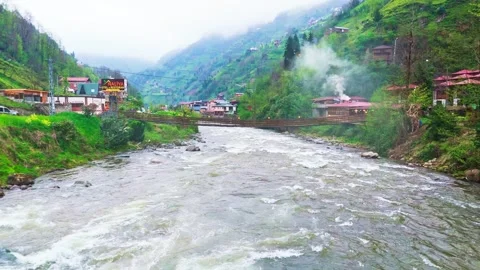 A river flowing through a lush green valley Video stock 272791196