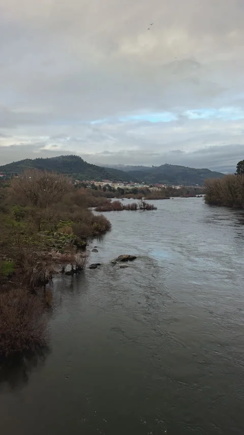 River Flowing Through a Misty Landscape Stock Footage 275675149