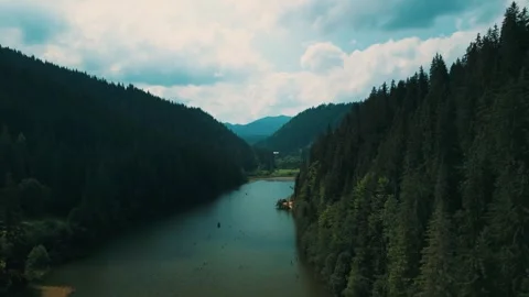 River flowing through mountains with lush trees Stock Footage 270244098